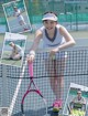 A woman holding a tennis racket on a tennis court.