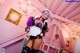 A woman dressed in a maid outfit posing for a picture.
