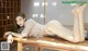 A woman laying on top of a wooden table.