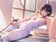 A woman in a white outfit laying on a table.