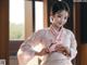 A woman in a pink hanbok is posing for a picture.